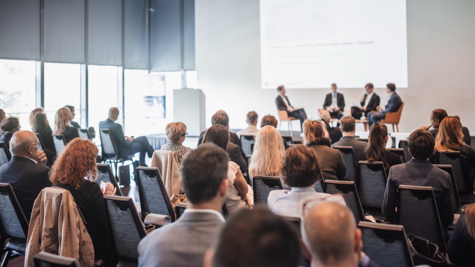 Audience watching a panel discussion at a business event